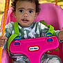Peyton is registered to the contest to win money with this photo: child, toddler, swing, pink, orange, ropes, curly_hair, big_eyes, pajamas, floral_pattern, outdoor, playground, seat, safety_strap, holding, person, baby, cute, daylight, nature