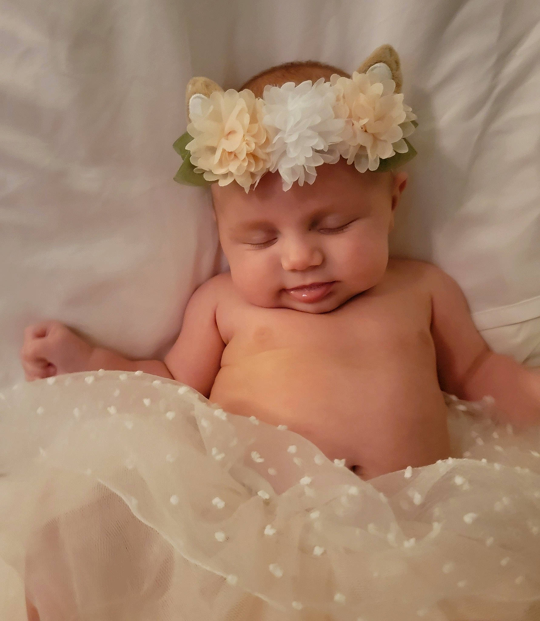 Olivia is registered to the contest to win money with this photo: baby, baby_toddler_clothing, bridal_accessory, child, embellishment, event, fashion_accessory, flash_photography, flower, hair_accessory, happy, headband, headgear, headpiece, headwear, jewellery, peach, person, petal, skin