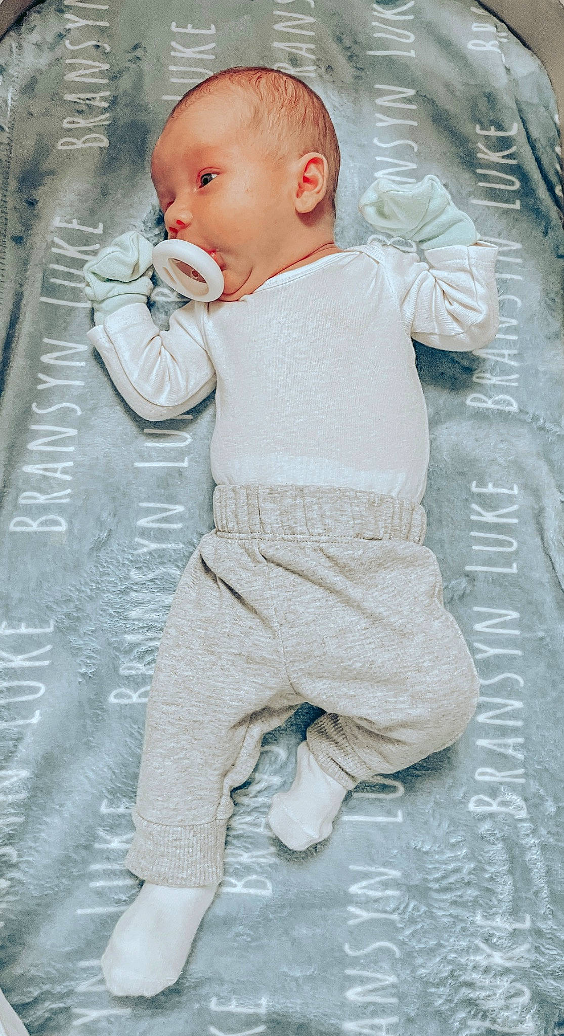 Bransyn is registered to the contest to win money with this photo: baby, baby_toddler_clothing, child, comfort, face, flooring, fur, head, leg, linens, pajamas, pattern, person, photograph, sitting, skin, sleeve, toddler, vacation