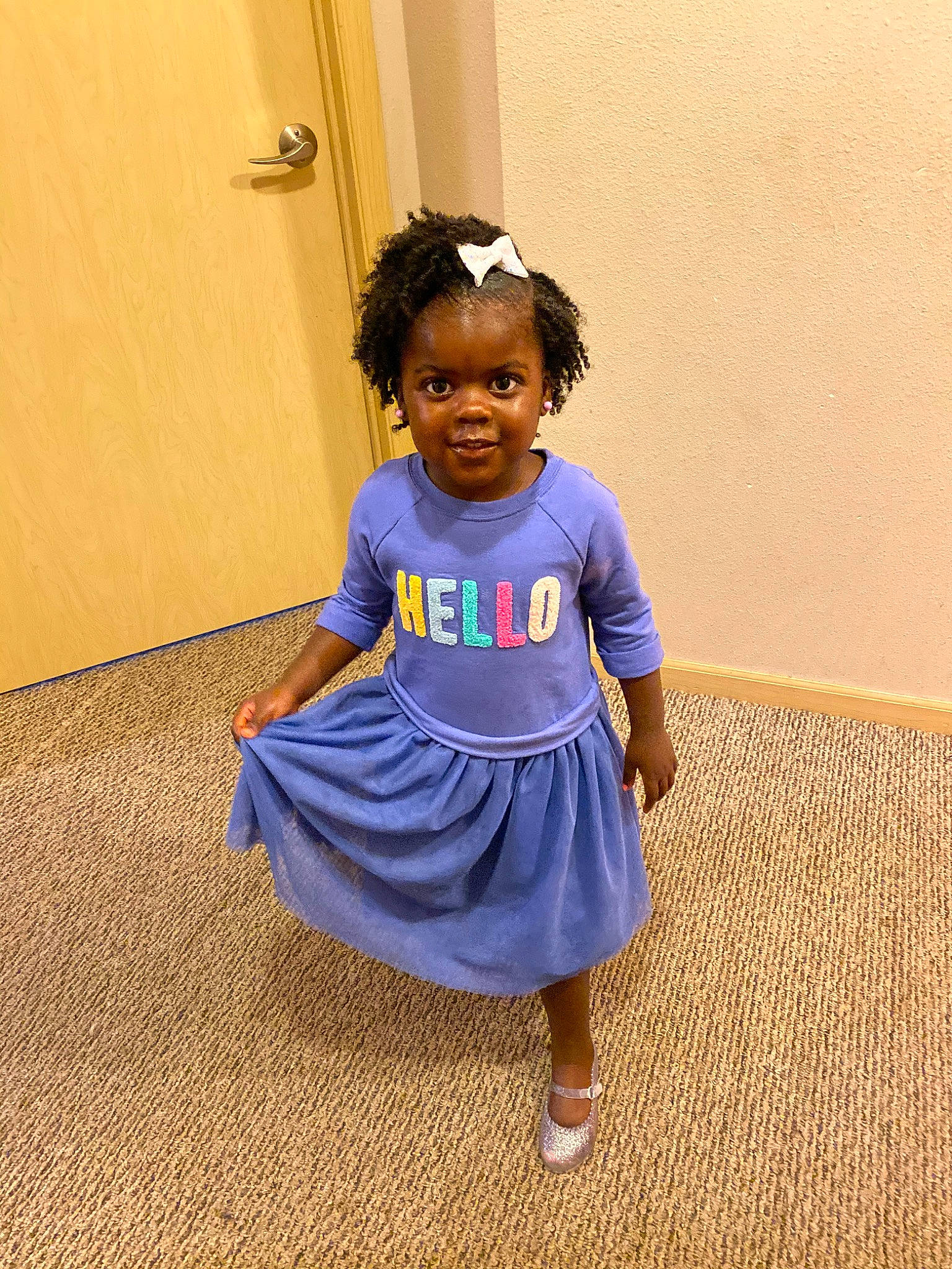 Kelsie is registered to the contest to win money with this photo: blue, child, dress, floor, hairstyle, person, play, purple, shoulder, smile, standing, t_shirt, toddler, vacation