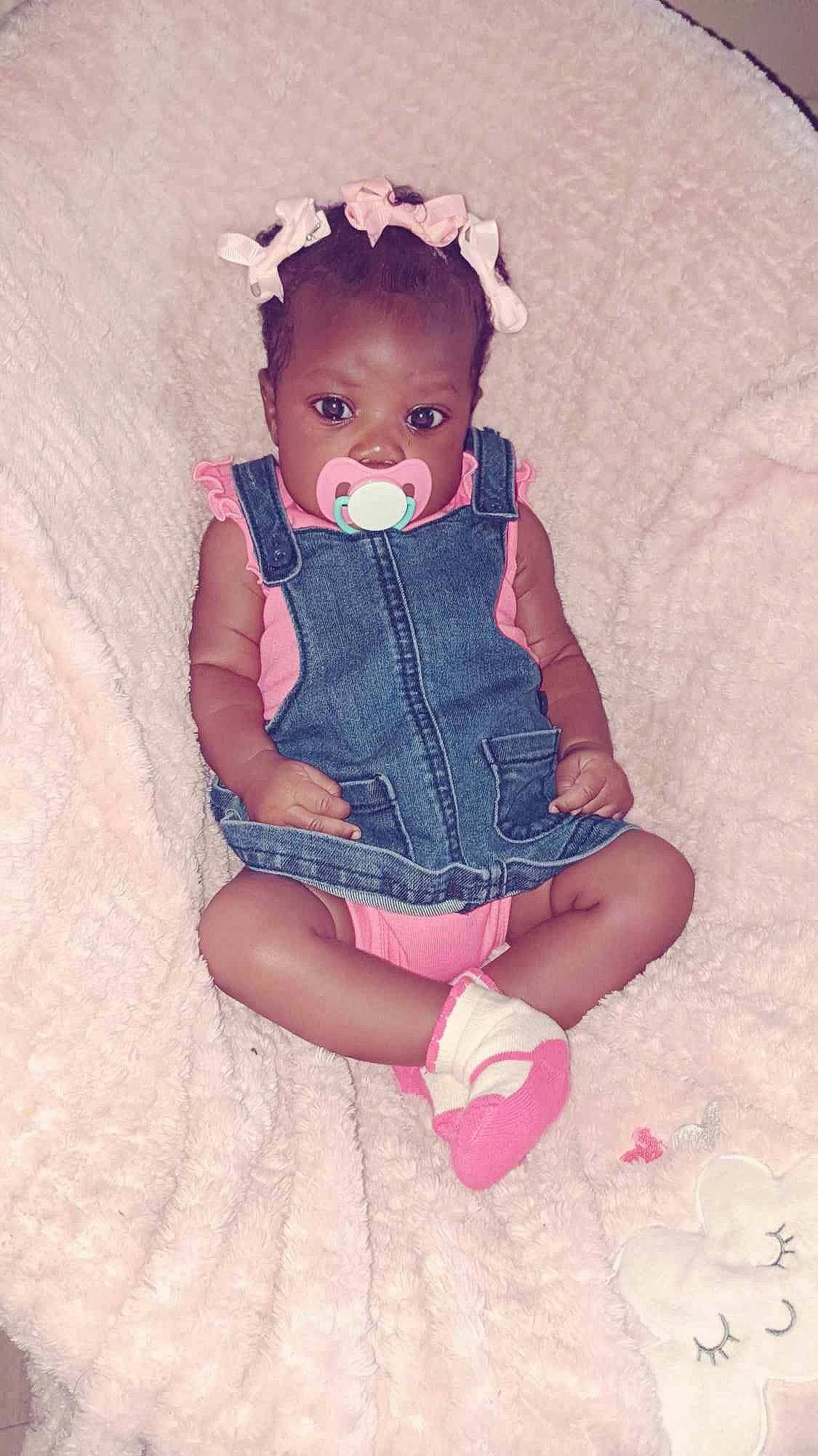 Zoey is registered to the contest to win money with this photo: baby, baby_toddler_clothing, child, day_dress, dress, electric_blue, embellishment, fashion_accessory, human_body, human_leg, magenta, pattern, person, pink, purple, skin, sleeve, sock, textile, thigh