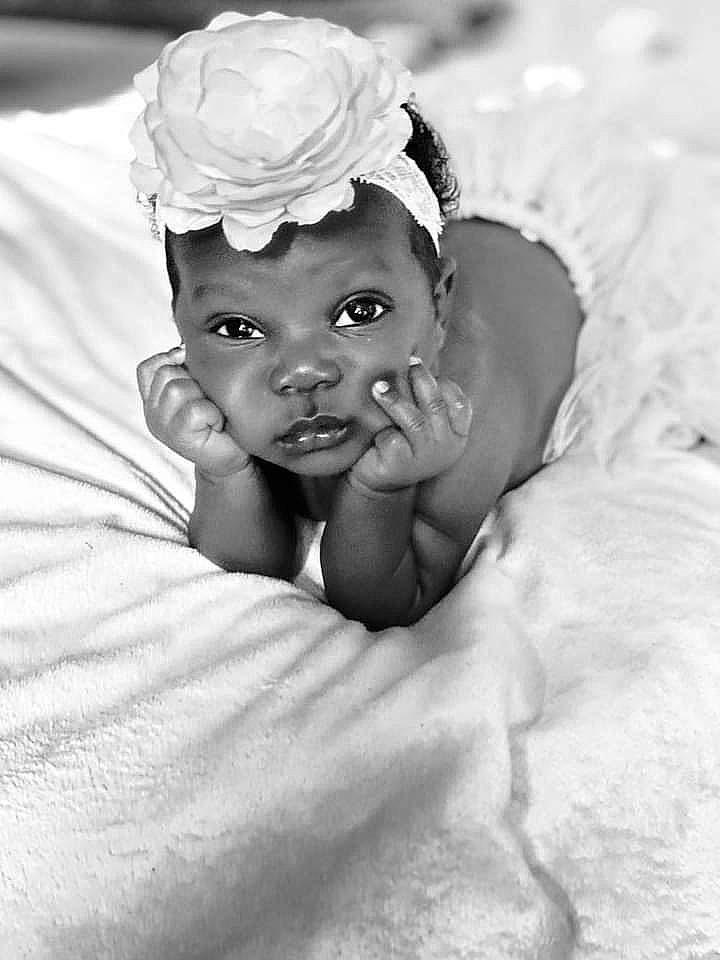 Zoey joined the competition — help win amazing prizes! art, baby, baby_toddler_clothing, chin, comfort, eye, flash_photography, flower, happy, headband, headgear, headpiece, iris, monochrome, monochrome_photography, person, petal, plant, sitting, smile