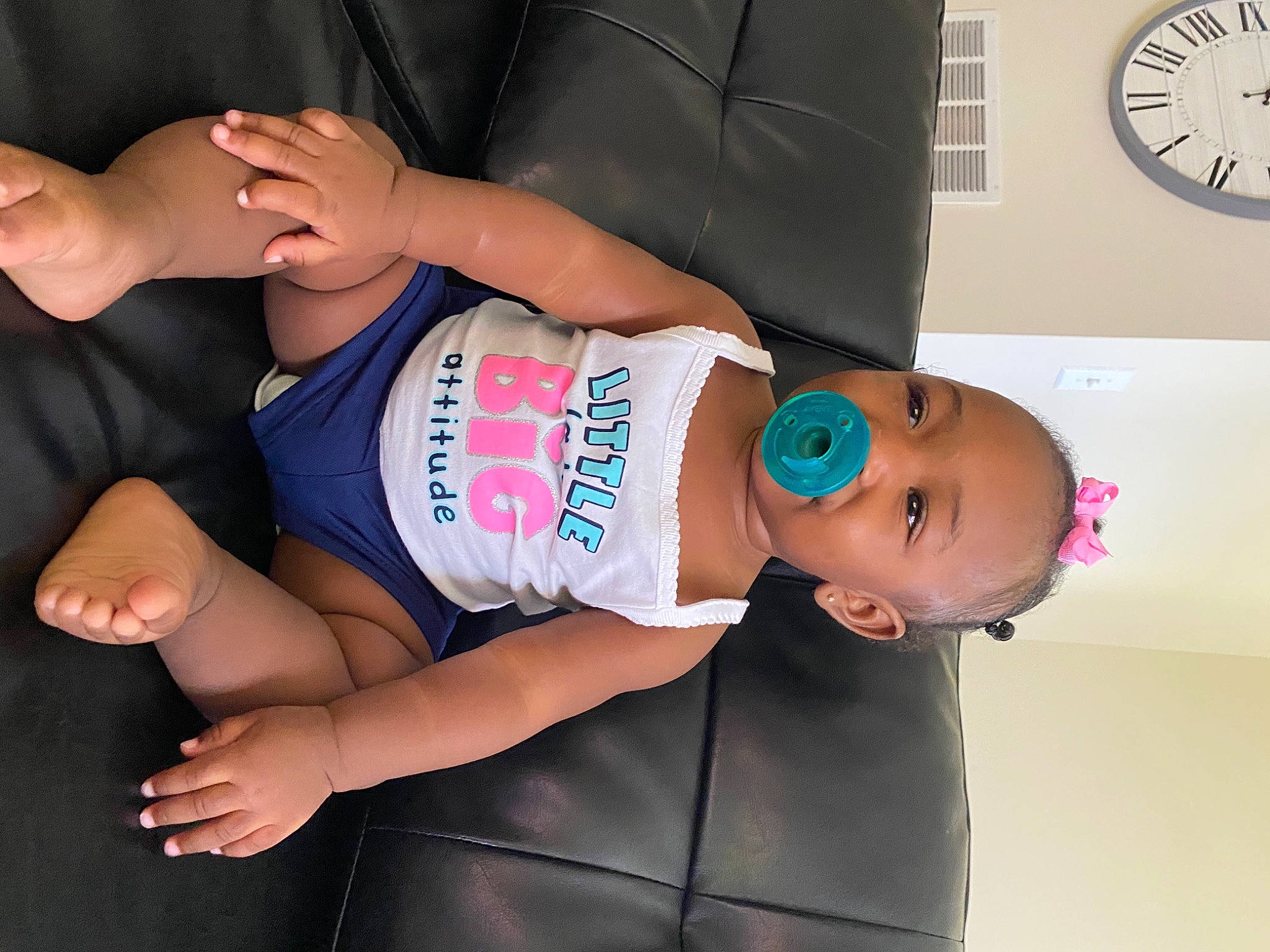 Camille is registered to the contest to win money with this photo: arm, baby_toddler_clothing, child, clock, comfort, elbow, finger, gesture, hand, human_leg, joint, knee, leg, person, shoulder, sleeve, thigh, toddler, trunk, waist