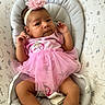Mariah is registered to the contest to win money with this photo: baby, infant, pink_tutu, headband, flower, baby_seat, bunny_pattern, cute, child, footwear, white_shoes, cushion, indoor, portrait, newborn, clothing, baby_girl, relaxed, expression, small_hands