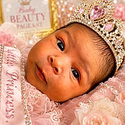 Mariah is registered to the contest to win money with this photo: baby, infant, crown, jewelry, pink, lace, sash, little_princess, portrait, face, newborn, flower, soft_texture, cute, baby_beauty_pageant, headwear, closeup, decorative, royalty, adorable
