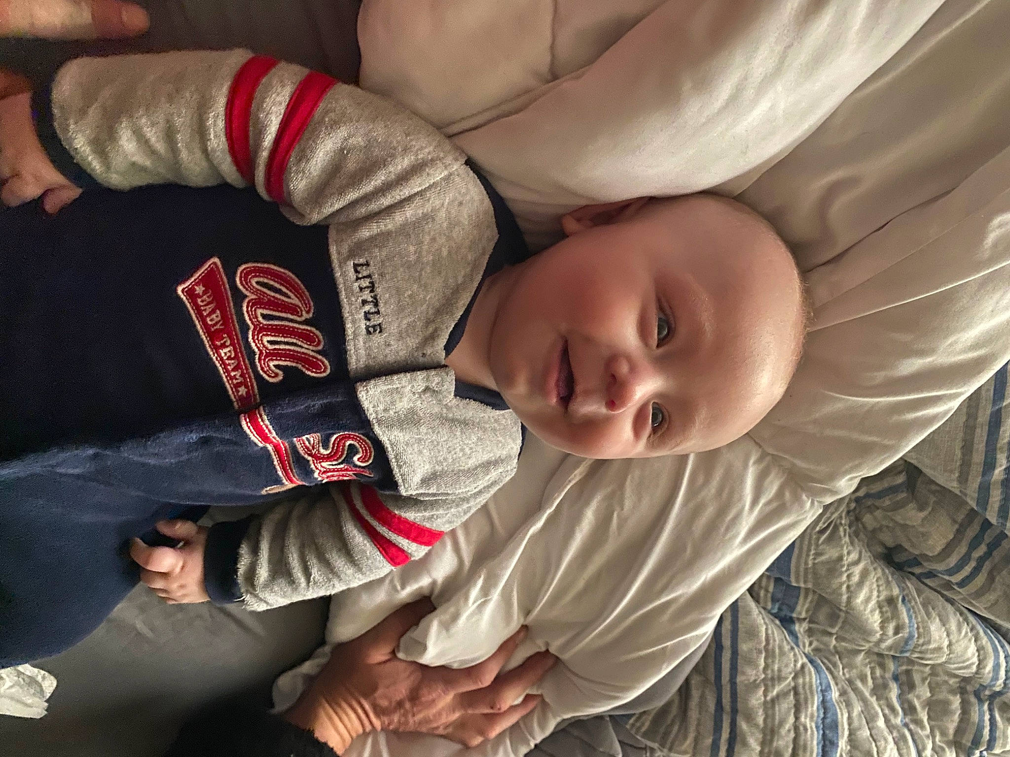 Kamdyn is registered to the contest to win money with this photo: arm, baby, carmine, child, comfort, elbow, finger, fun, gesture, hairstyle, hand, happy, human_leg, knee, mouth, person, sitting, sleeve, thigh, toddler