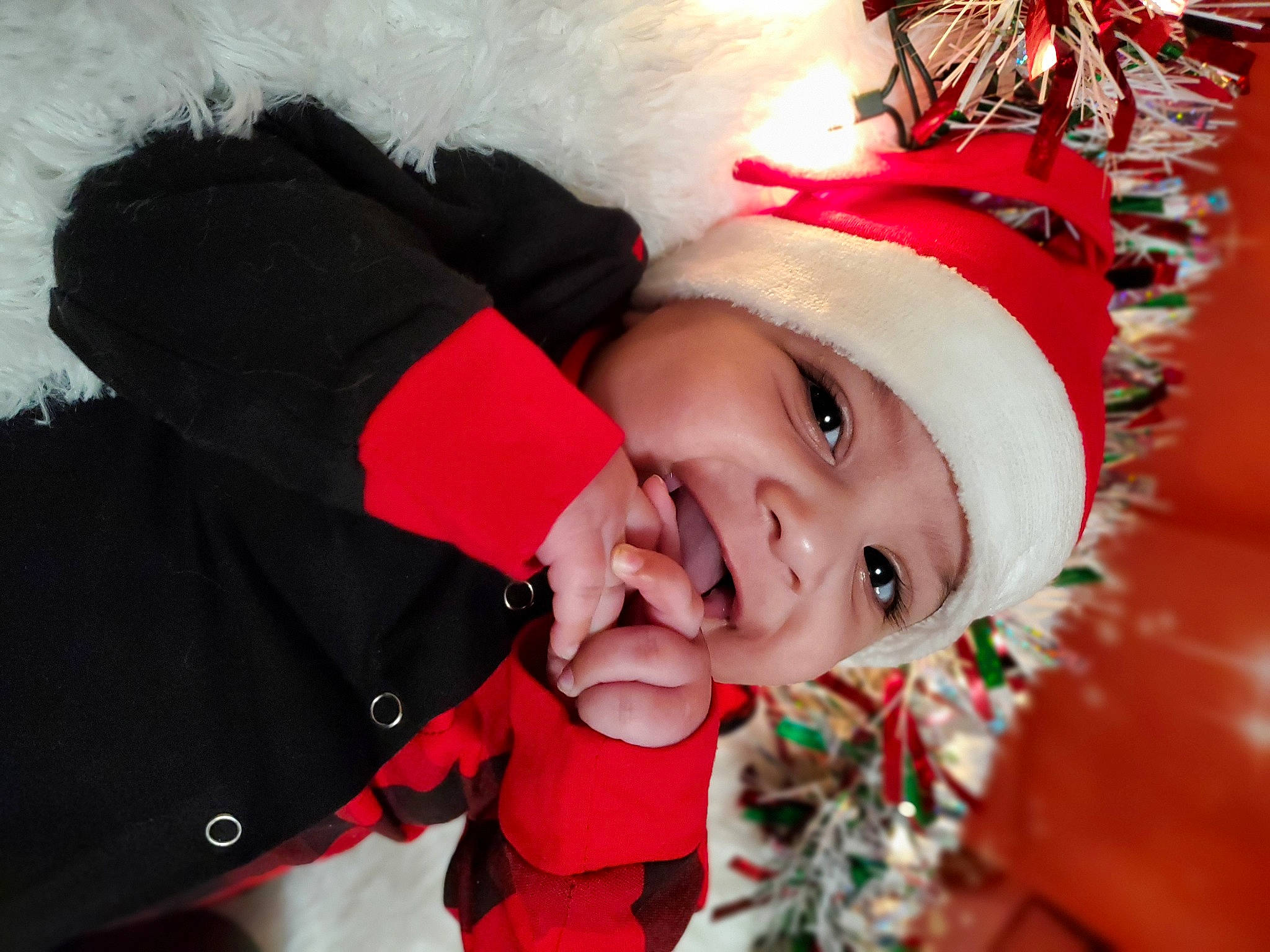 Michael is registered to the contest to win money with this photo: baby, carmine, child, christmas_eve, christmas_ornament, christmas_tree, event, fictional_character, fun, fur, happy, headwear, holiday, laugh, leisure, person, smile, snow, toddler, tradition