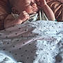 baby, bed, blanket, child, comfort, cozy, cute, face, hand, indoors, infant, newborn, peaceful, portrait, quiet, resting, sleeping, soft_light, star_pattern, tucked_in
