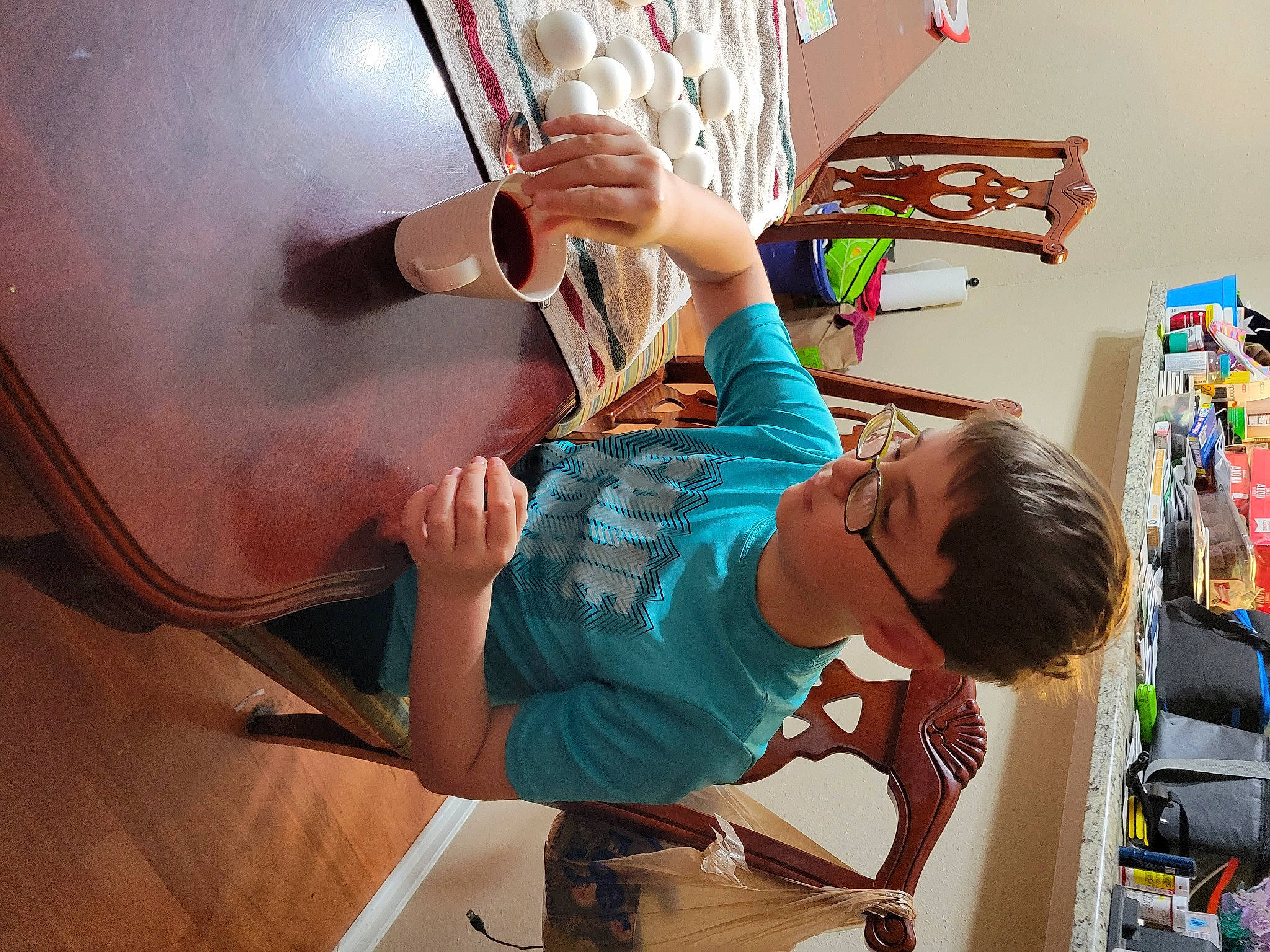 Lexton is registered to the contest to win money with this photo: art, artist, chair, child, desk, eyewear, fun, illustration, learning, leisure, people, person, play, room, sandal, sitting, t_shirt, table, toddler, visual_arts