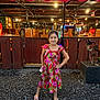 american_flags, canopy, casual, child, coca_cola, dress, flip_flops, flower, girl, gravel, happy, lights, night, outdoor, plant, portrait, posing, restaurant, smiling, wooden_booths