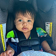Athena joined the competition — help win amazing prizes! baby, child, car_seat, seat_belt, pacifier, blanket, clothing, face, human, infant, sitting, straps, safety, cute, portrait, indoors, young_child, expression, comfort, closeup