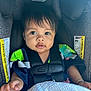 baby, child, car_seat, seat_belt, pacifier, blanket, clothing, face, human, infant, sitting, straps, safety, cute, portrait, indoors, young_child, expression, comfort, closeup