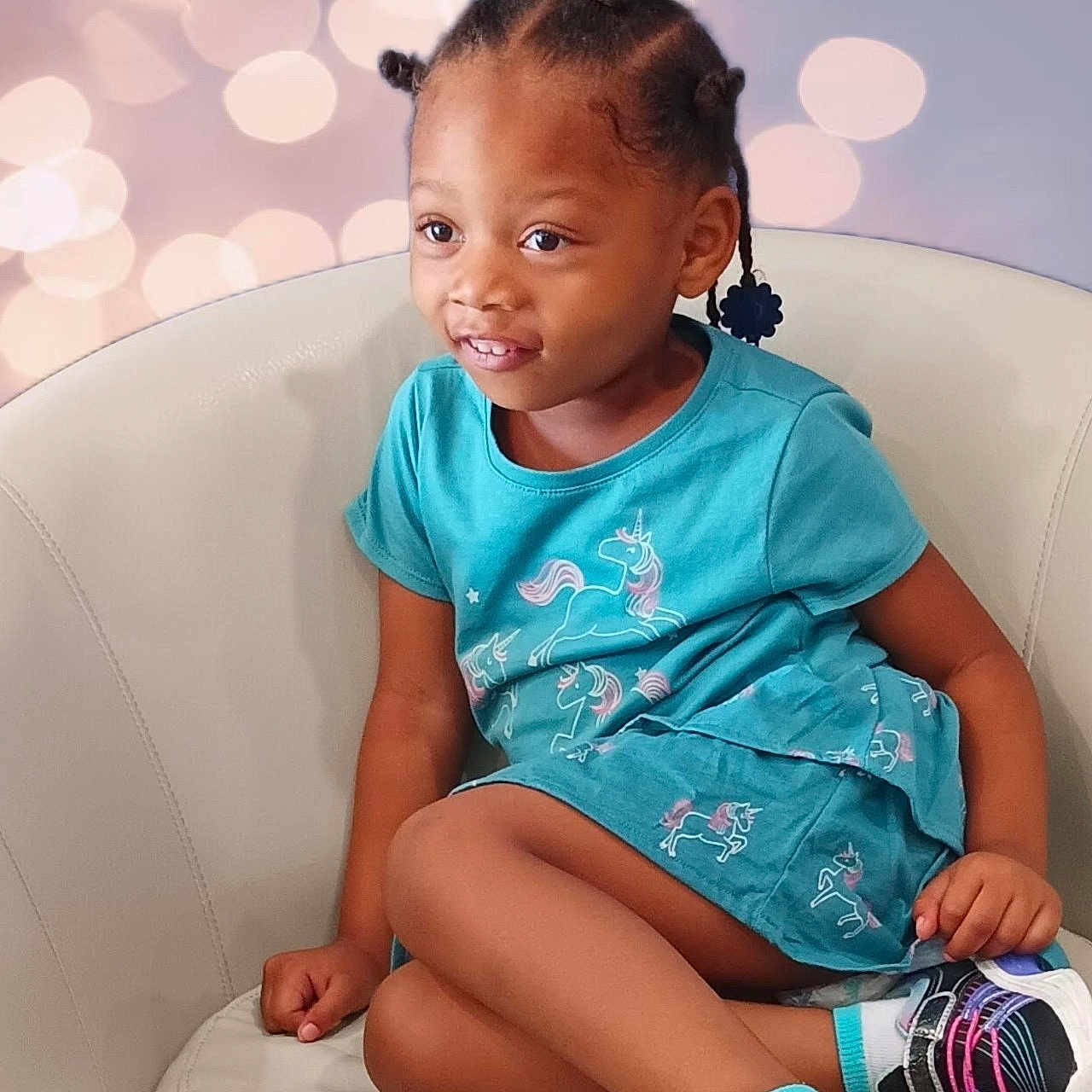 Da'Nay Lynn is registered to the contest to win money with this photo: background_bokeh, bantu_knots, braided_hair, casual, chair, child, colorful, crossed_legs, cute, fashion, girl, happy, indoor, person, portrait, sitting, smiling, sneakers, unicorn_dress, young