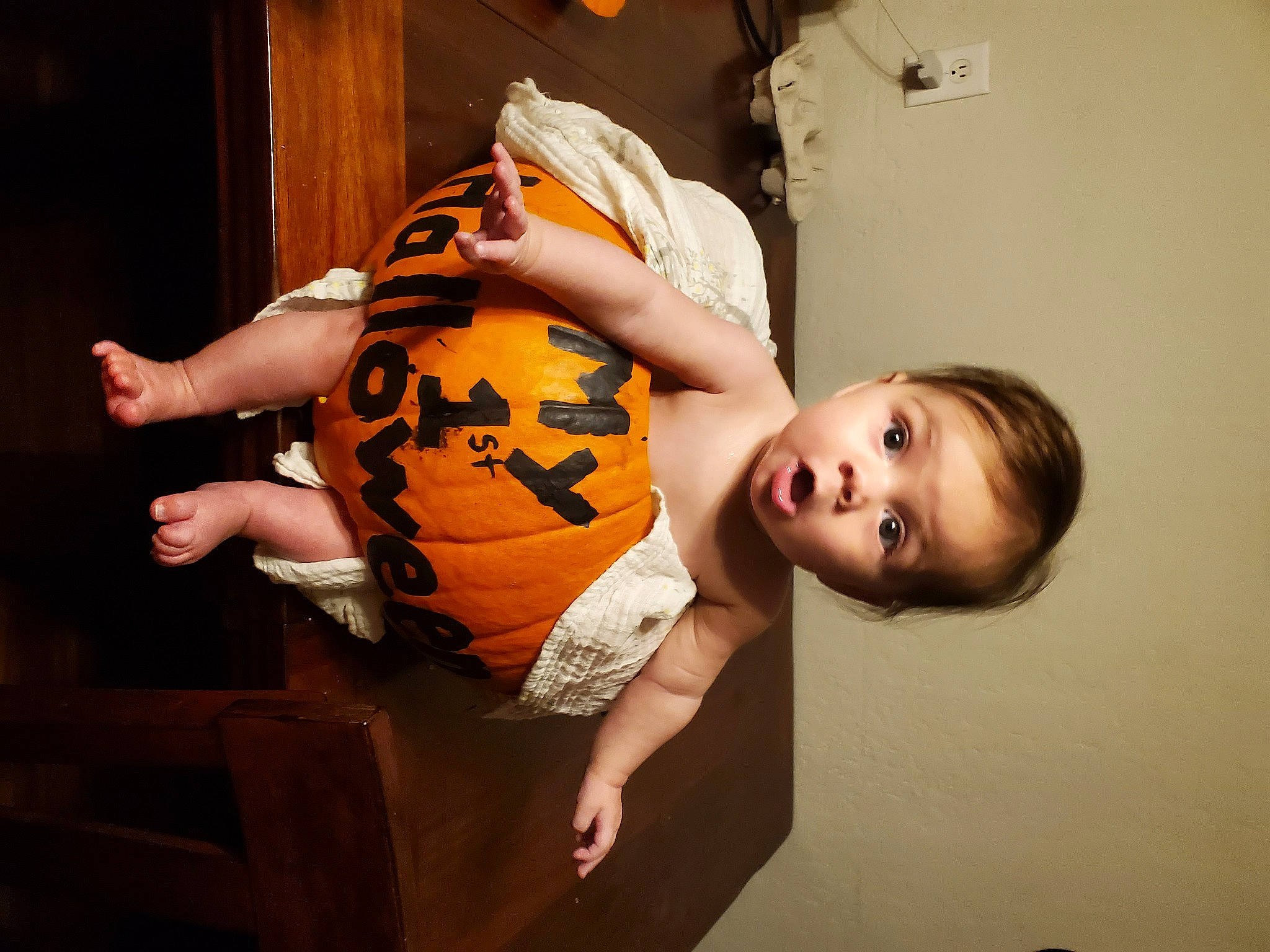 Winry is registered to the contest to win money with this photo: abdomen, arm, baby, calabaza, child, elbow, finger, flash_photography, fun, happy, human_leg, mouth, person, pumpkin, room, sitting, stuffed_toy, surprise, thigh, toddler
