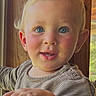 toddler, child, face, blue_eyes, blond_hair, rosy_cheeks, striped_shirt, hand, window, wood_paneling, indoors, portrait, curious, baby, person, smiling, natural_light, young_child, cute, expression