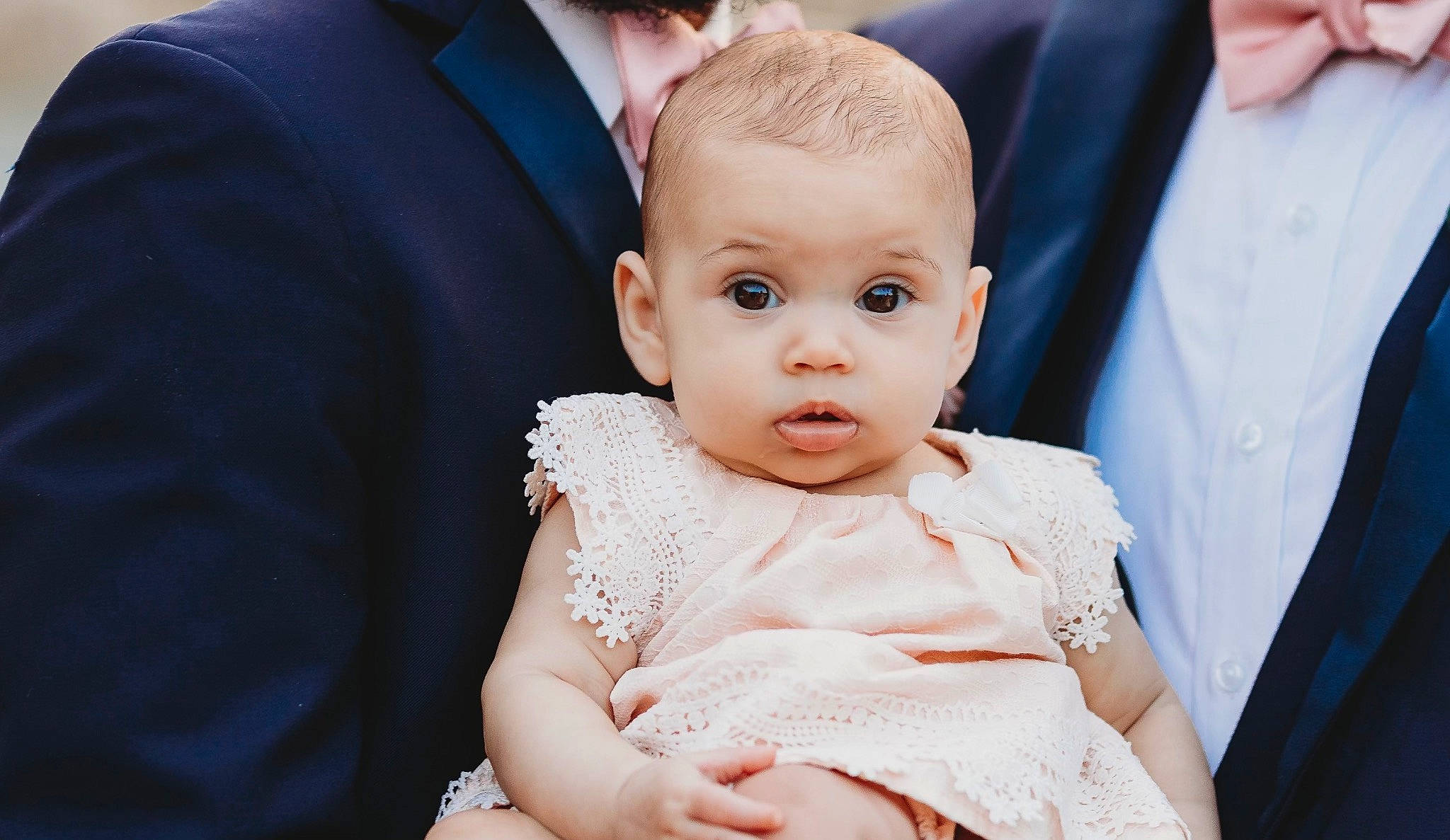 Aubree is registered to the contest to win money with this photo: baby, baby_toddler_clothing, ceremony, child, clothing, dress, event, flash_photography, formal_wear, gesture, gown, happy, jewellery, person, sitting, skin, suit, toddler, tradition, wedding