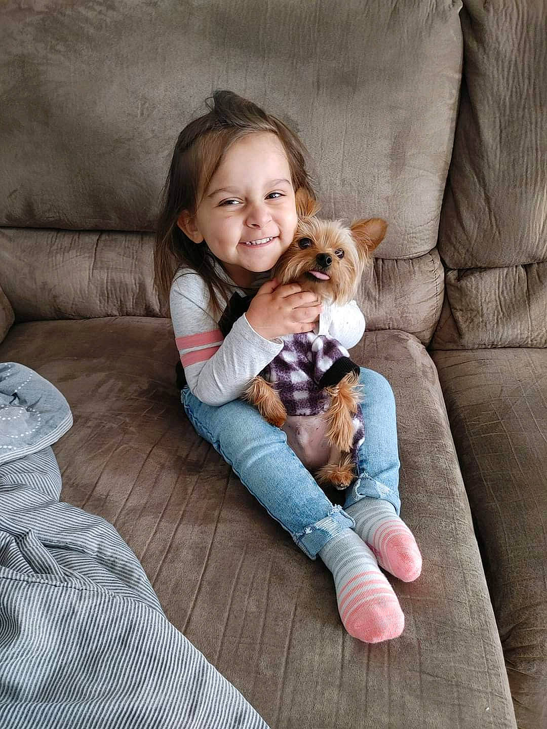 Autumn is registered to the contest to win money with this photo: beauty, blond, carnivore, child, comfort, companion_dog, couch, fawn, foot, hair, hairstyle, happy, human_leg, joy, lap, leg, person, sitting, skin, smile