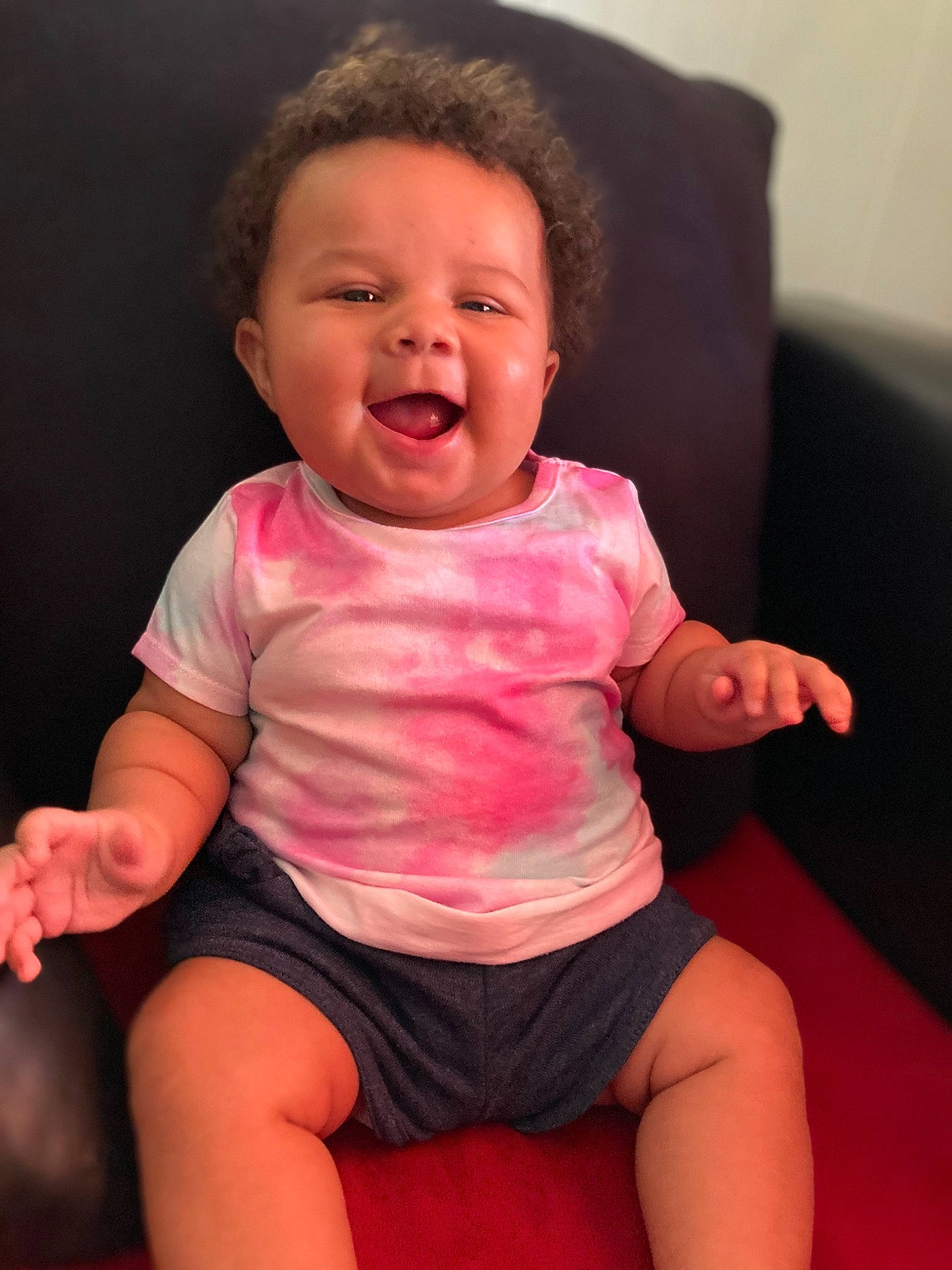 Harmoni is registered to the contest to win money with this photo: baby_toddler_clothing, cheek, comfort, eye, finger, gesture, happy, head, human_body, joint, lip, mouth, neck, nose, person, pink, shorts, skin, sleeve, smile