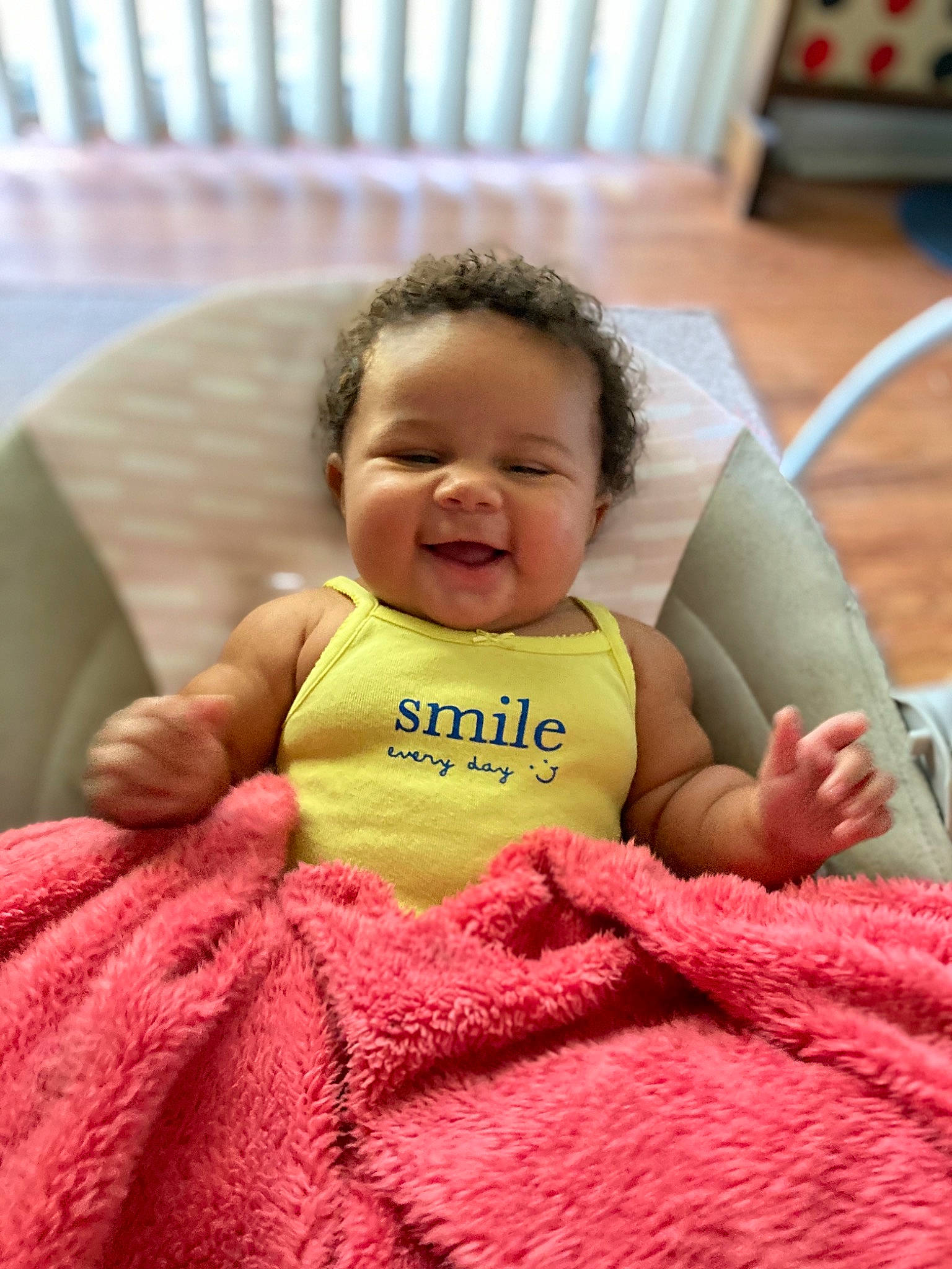 Harmoni is registered to the contest to win money with this photo: baby, baby_toddler_clothing, chair, cheek, child, comfort, couch, face, finger, fun, happy, head, mammal, person, pink, sitting, skin, sleeve, smile, thumb