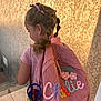 accessory, backpack, braided_hair, casual, child, colorful, embroidered, flowers, girl, outdoor, pink_shirt, ribbons, shadow, side_view, sunlight, texture, wall, water_bottle, young_person, youth