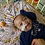 Esmari is registered to the contest to win money with this photo: baby, bed, blanket, blue, child, clothing, comfort, crib, cute, face, hand, healthcare, hospital, infant, medical_tube, nasal_cannula, person, pink, smiling, teddy_bear_pattern