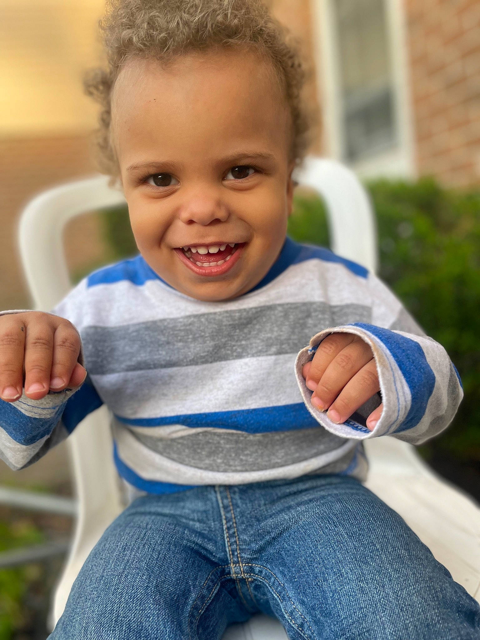 Dreytonn is registered to the contest to win money with this photo: baby_toddler_clothing, clothing, eye, face, finger, gesture, grass, hair, hairstyle, hand, happy, head, human_body, jeans, joy, leg, muscle, person, plant, shoulder