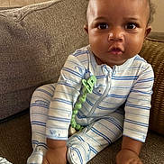 Khaleel joined the competition — help win amazing prizes! adorable, baby, carpet, child, couch, curly_hair, cushion, eyes, face, furniture, home, indoor, infant, pacifier_clip, pajamas, photography, portrait, sitting, striped_clothing, textile