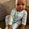 adorable, baby, carpet, child, couch, curly_hair, cushion, eyes, face, furniture, home, indoor, infant, pacifier_clip, pajamas, photography, portrait, sitting, striped_clothing, textile
