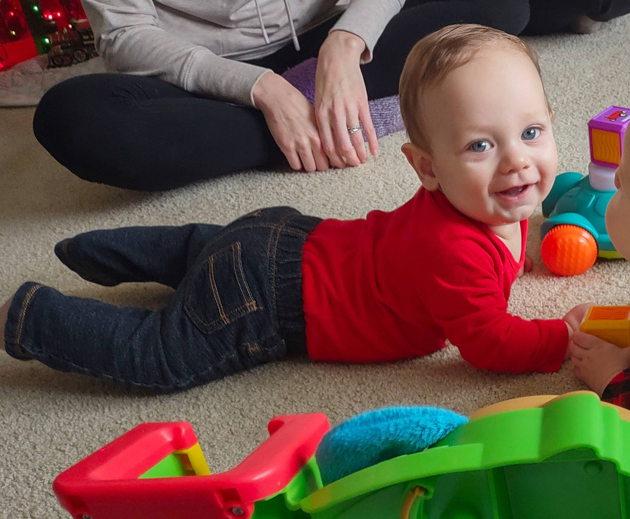 Memphis joined the competition — help win amazing prizes! baby, baby_playing_with_toys, baby_toddler_clothing, child, comfort, crawling, flooring, foot, fun, happy, human_leg, joy, leg, leisure, person, red, sitting, smile, toddler, toy