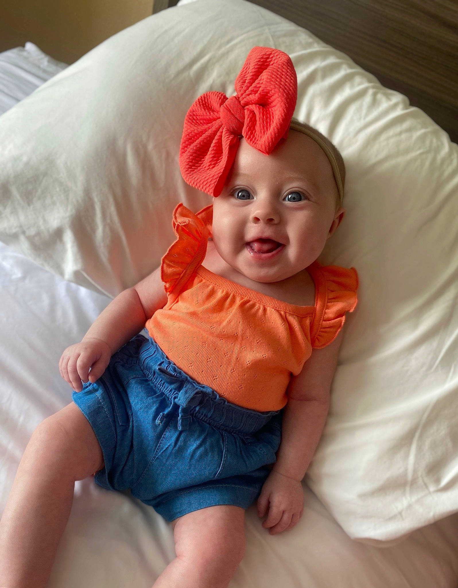 Callie is registered to the contest to win money with this photo: baby, baby_toddler_clothing, child, comfort, dress, electric_blue, eye, happy, head, headwear, human_body, human_leg, orange, pattern, peach, person, pink, skin, sleeve, smile