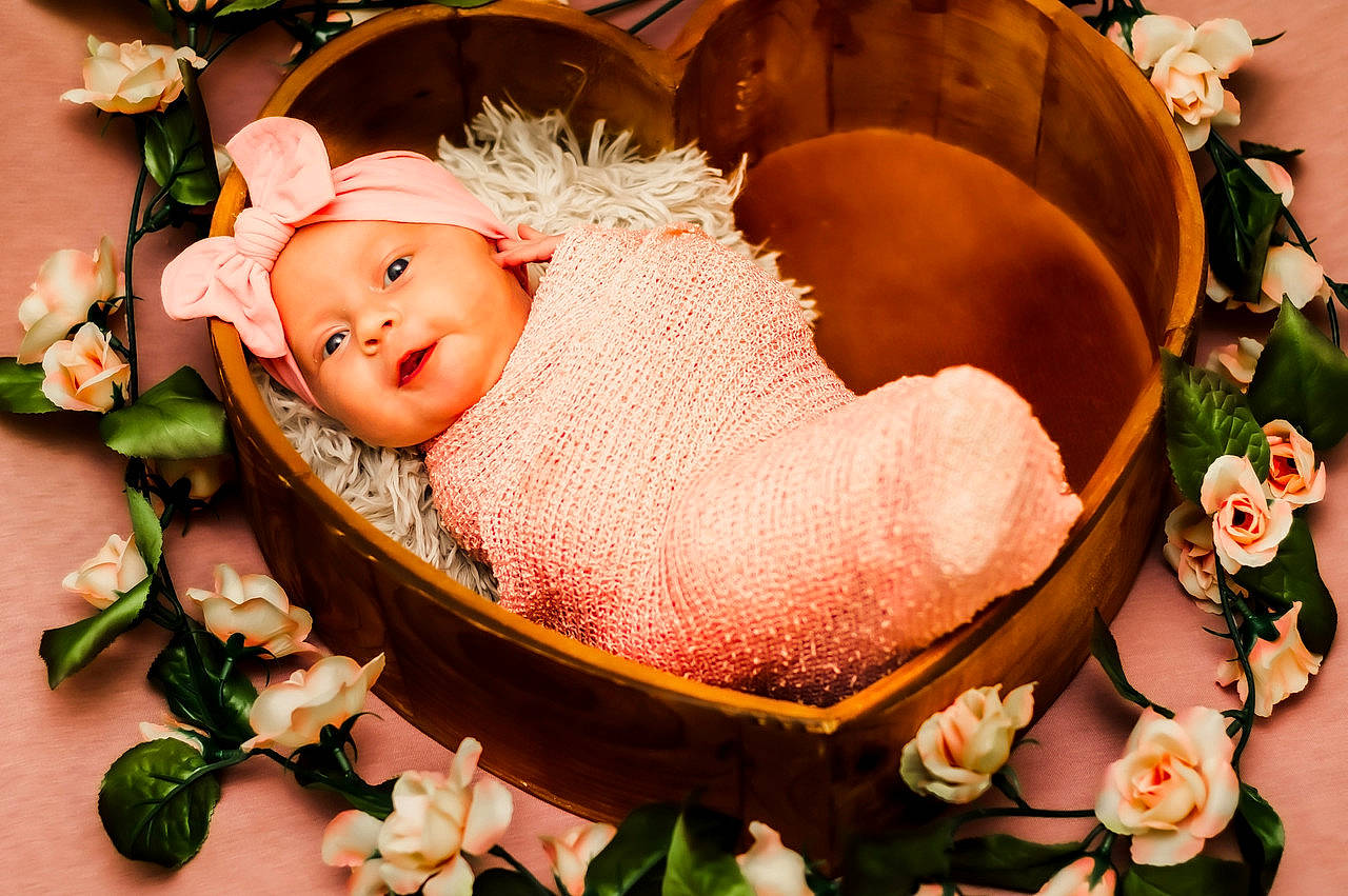 Callie is registered to the contest to win money with this photo: art, baby, baby_products, basket, child, cut_flowers, event, fashion_accessory, flower, flower_arranging, grass, happy, headwear, ornament, peach, person, petal, pink, plant, sweetness