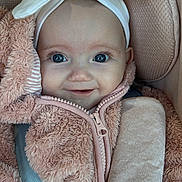 Christine-Rose joined the competition — help win amazing prizes! baby, blue_eyes, bow, car_seat, child, closeup, clothing, cute, face, furry, happy, headband, indoor, infant, jacket, person, pink, portrait, seatbelt, smile