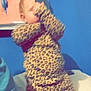 baby, leopard_print, clothing, child, standing, blue_wall, towel, indoor, person, blurred, covering_face, young_child, infant, patterned_clothing, fabric, soft_toys, bed, home, casual, cute