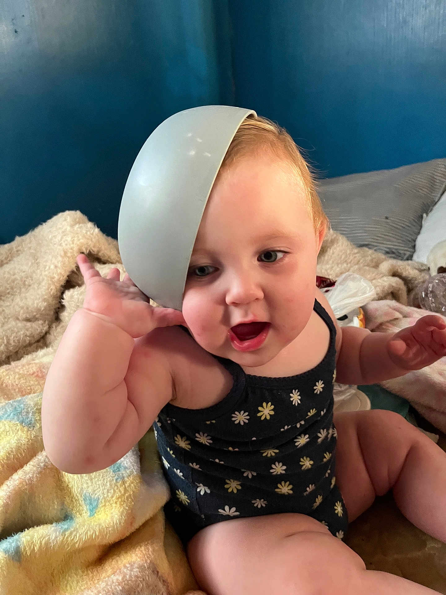 Clariece joined the competition — help win amazing prizes! baby, child, face, onesie, blanket, bowl, headwear, indoor, cute, chubby, expression, playful, sitting, pillow, furniture, person, skin, hand, mouth_open, curly_hair