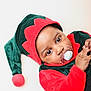 Nael participe au concours pour gagner de l'argent avec cette photo : baby, infant, child, pacifier, elf_costume, hat, red, green, cute, portrait, indoors, closeup, face, costume, holiday, festive, apparel, skin, expression, lying_down