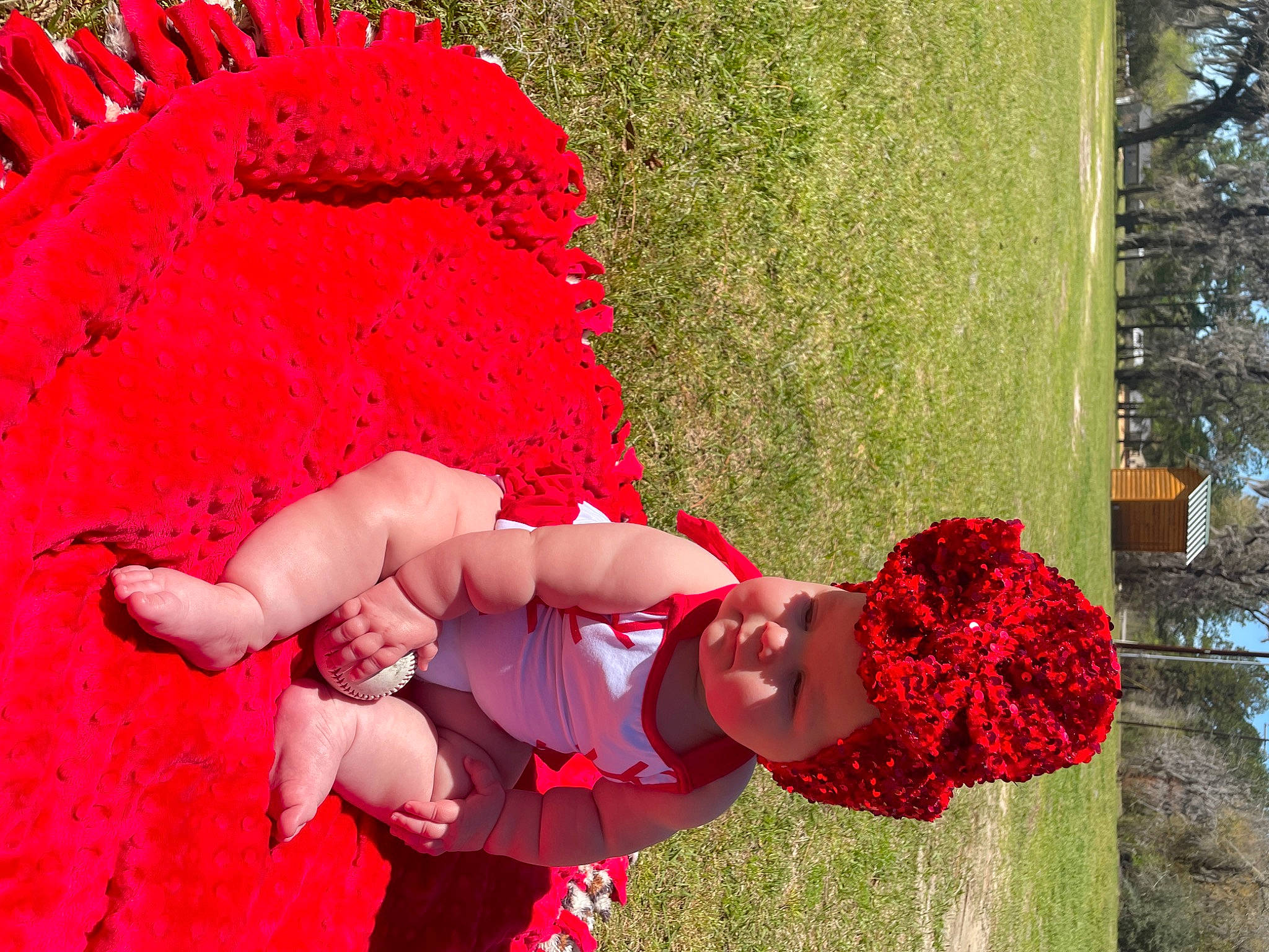 Mila is registered to the contest to win money with this photo: carmine, event, flower, fun, grass, happy, headwear, leaf, leisure, magenta, people_in_nature, person, petal, pink, plant, red, shrub, smile, textile, toddler