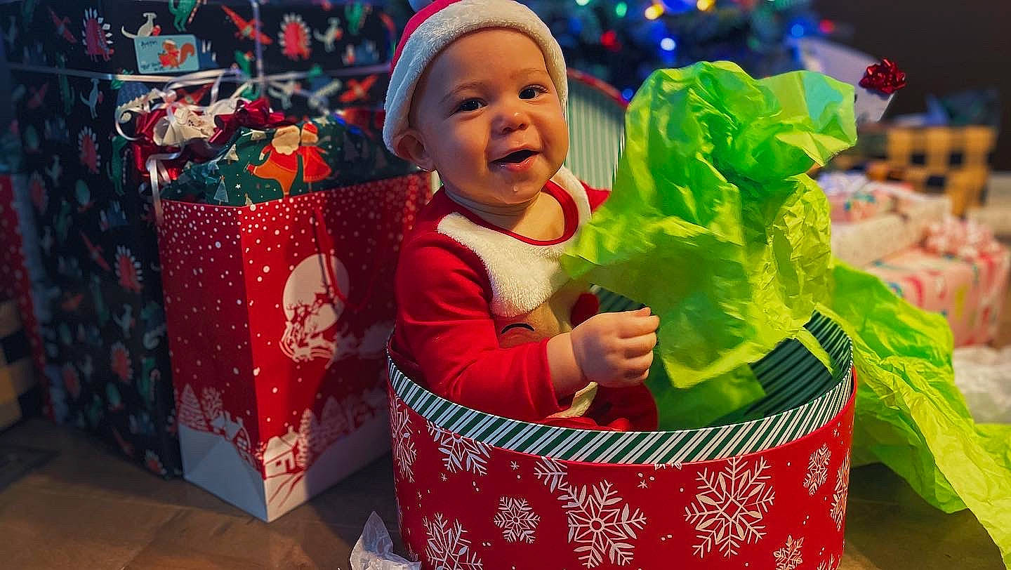 Henry joined the competition — help win amazing prizes! basket, carmine, child, christmas, christmas_decoration, christmas_eve, christmas_ornament, event, fun, green, happy, headwear, holiday, holiday_ornament, party_supply, people_in_nature, person, red, smile, toddler