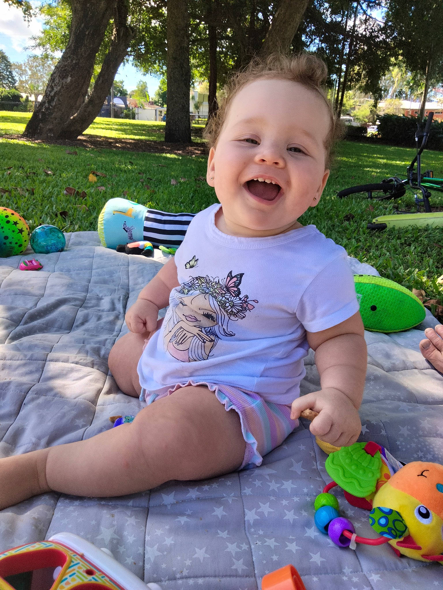 Jazmin joined the competition — help win amazing prizes! baby, baby_playing_with_toys, baby_toddler_clothing, child, fun, grass, green, happy, head, human_body, joy, leisure, people_in_nature, person, plant, recreation, shorts, sitting, smile, toddler