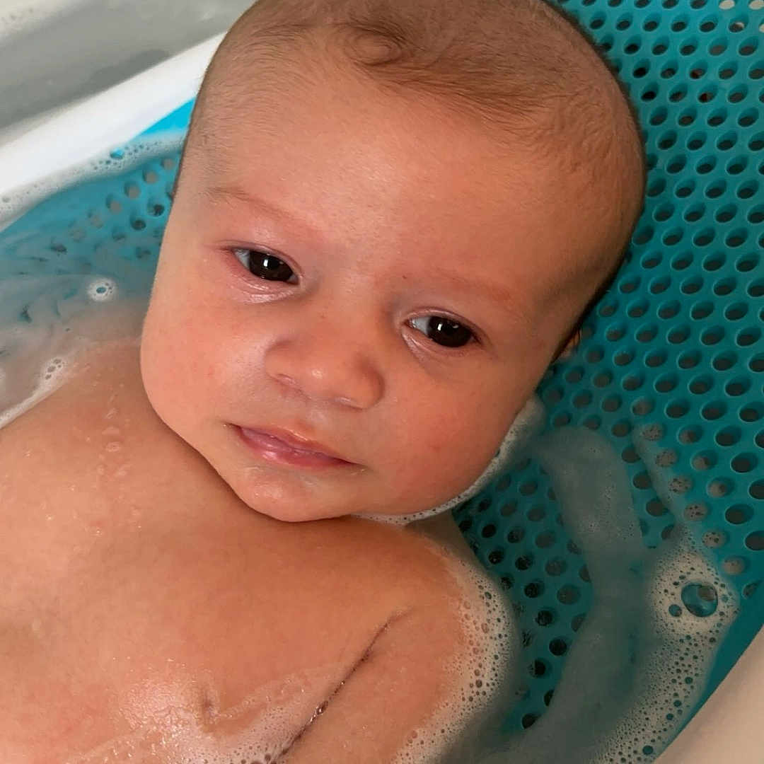 Hudson is registered to the contest to win money with this photo: baby, bathing, bathtub, face, head, newborn, person, photography, portrait, tub, washing