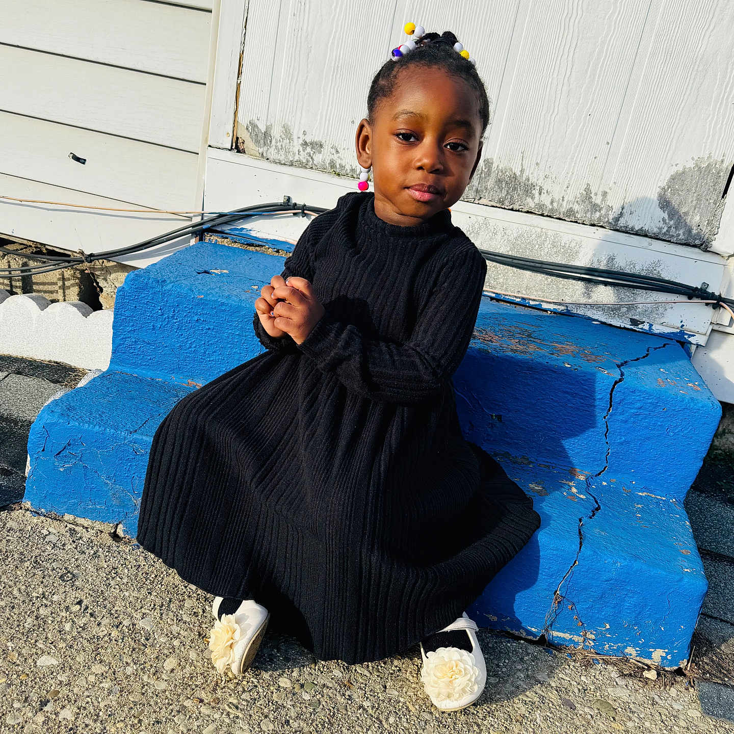 Daniella is registered to the contest to win money with this photo: bodypart, child, clothing, dress, face, female, finger, girl, hand, happy, head, knitwear, longsleeve, person, photography, portrait, sitting, sleeve, smile, sweater