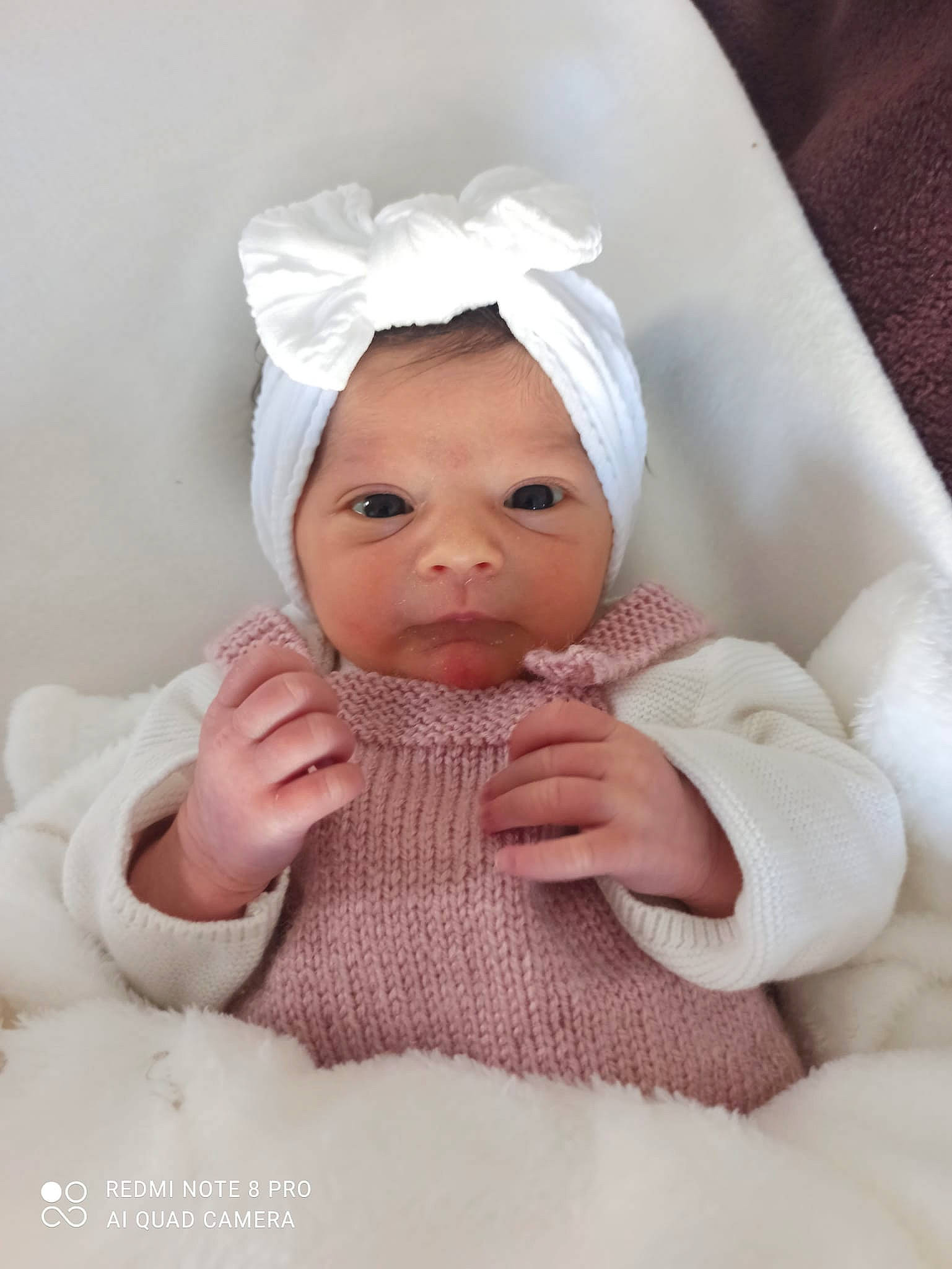 Anouchka participe au concours pour gagner de l'argent avec cette photo : baby, baby_products, baby_toddler_clothing, beanie, cap, cheek, child, comfort, eye, fashion_accessory, human_body, knit_cap, linens, nail, peach, person, sitting, sleeve, thumb, toddler