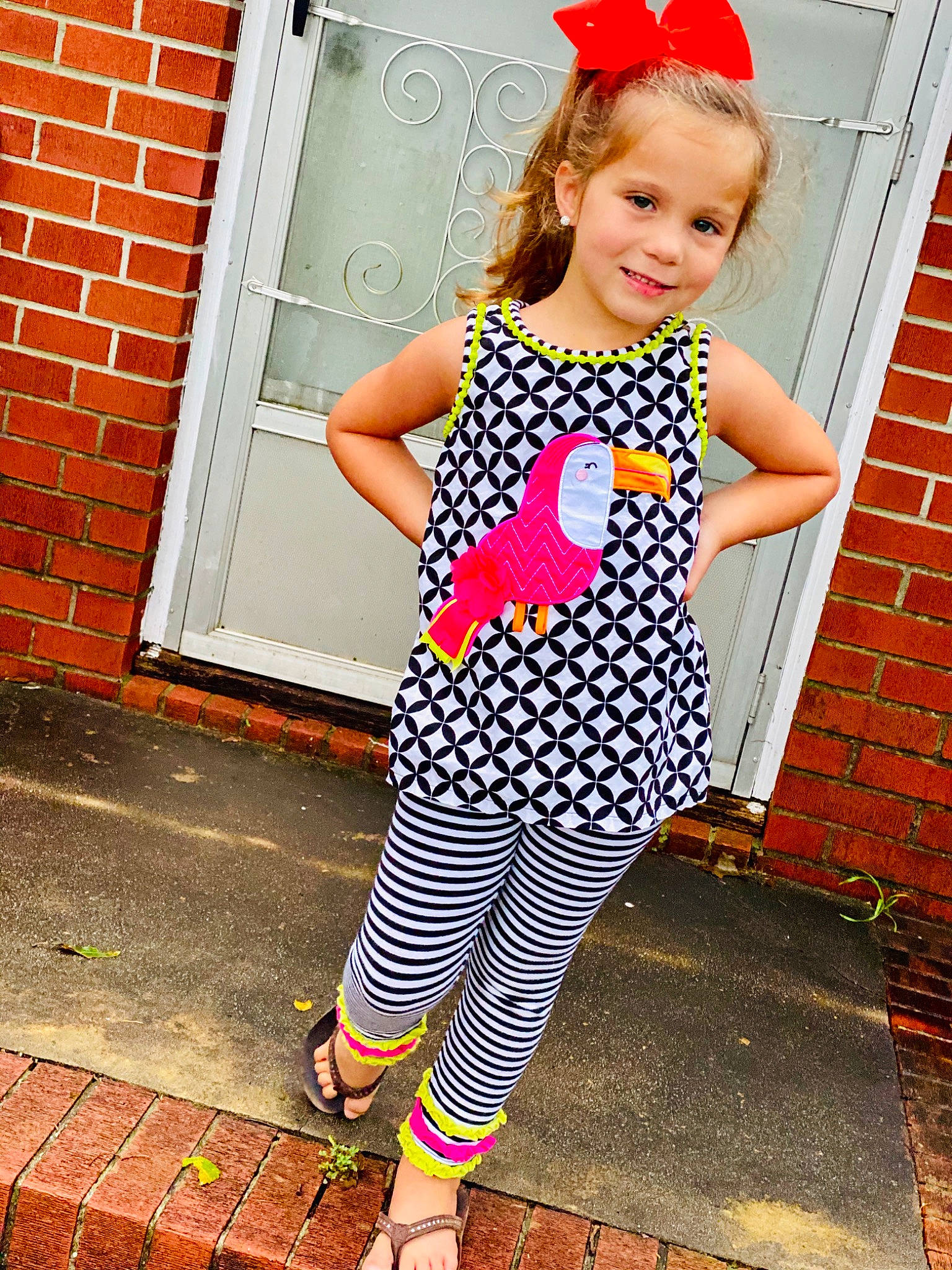 Ellie is registered to the contest to win money with this photo: baby_toddler_clothing, clothing, day_dress, dress, eyewear, happy, joy, knee, leg, one_piece_garment, orange, person, pink, red, shoe, sleeve, smile, standing, street_fashion, style