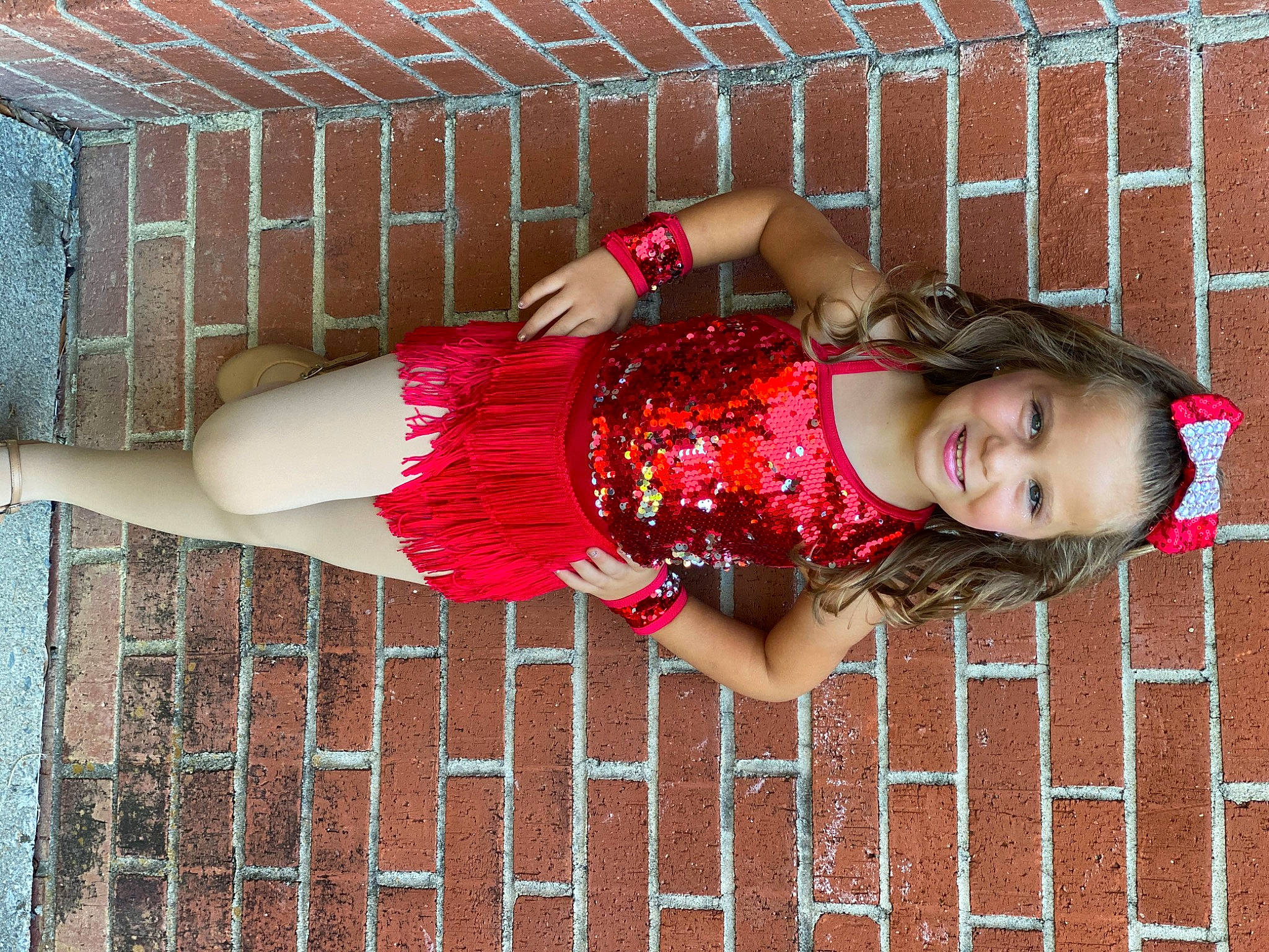 Ellie is registered to the contest to win money with this photo: arm, dress, fun, happy, human_leg, joint, joy, knee, leg, magenta, pattern, person, pink, red, skin, sleeve, smile, street_fashion, textile, thigh