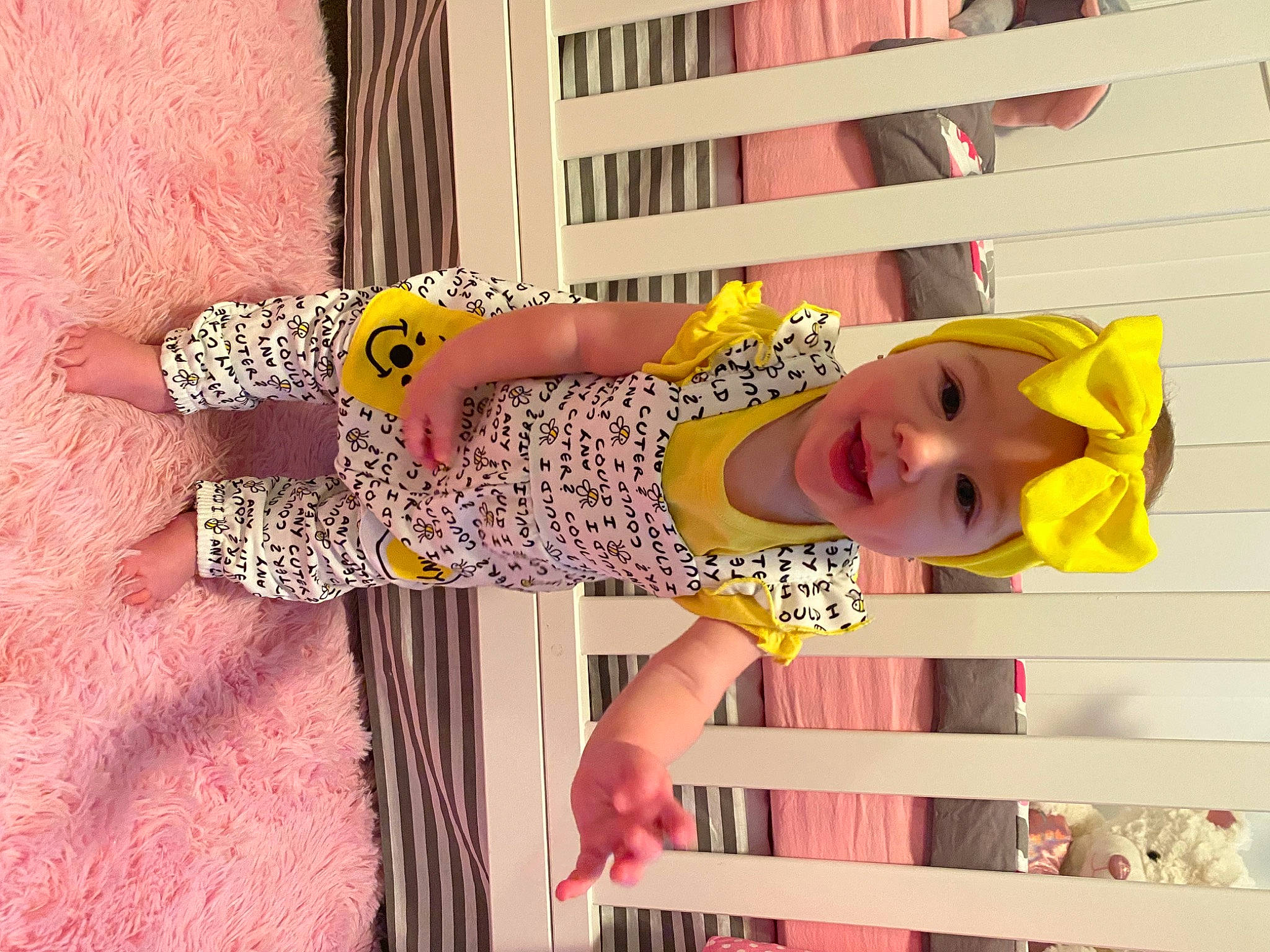 Adilynn joined the competition — help win amazing prizes! baby_products, baby_toddler_clothing, child, day_dress, dress, fun, happy, hat, headwear, magenta, one_piece_garment, pattern, person, pink, room, smile, thigh, toddler, wood, wrist