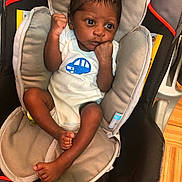 Davin is registered to the contest to win money with this photo: arm, car_seat, child, muscle, product