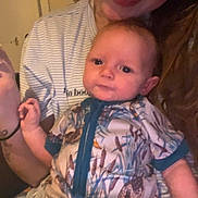 Lawson is registered to the contest to win money with this photo: baby, woman, indoor, smile, person, clothing, onesie, pattern, animal_print, holding, portrait, face, warm_light, casual, hair, expression, child, comfort, family, candid