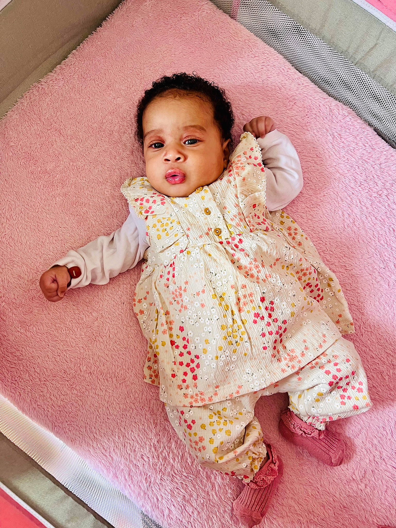 Mia Chance Merkel participe au concours pour gagner de l'argent avec cette photo : arm, baby, baby_toddler_clothing, cheek, chin, dress, eye, face, hair, head, human_body, iris, lip, nose, outerwear, person, pink, product, skin, sleeve