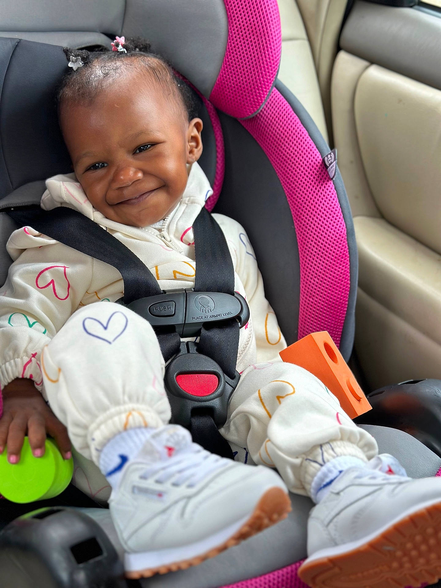 Ryleign is registered to the contest to win money with this photo: baby, car, car_interior, carseat, clothing, coat, face, footwear, happy, head, jacket, person, photography, portrait, shoe, sitting, smile, sneaker, transportation, vehicle