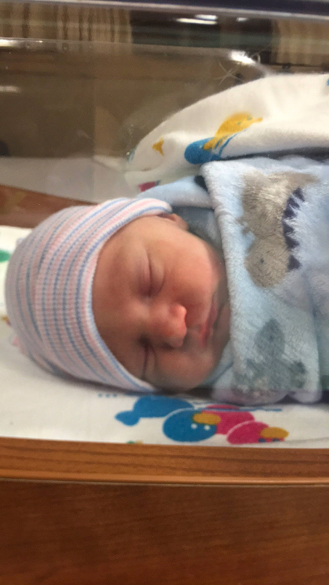 Keith is registered to the contest to win money with this photo: baby, baby_products, baby_safety, baby_sleeping, baby_toddler_clothing, bedtime, child, comfort, flooring, hat, linens, nap, person, room, sleep, toddler, wood