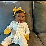 Halo Rae is registered to the contest to win money with this photo: accessories, baby, bodypart, clothing, couch, cushion, face, finger, furniture, glove, hand, happy, hat, head, homedecor, jewelry, person, photography, portrait, sitting